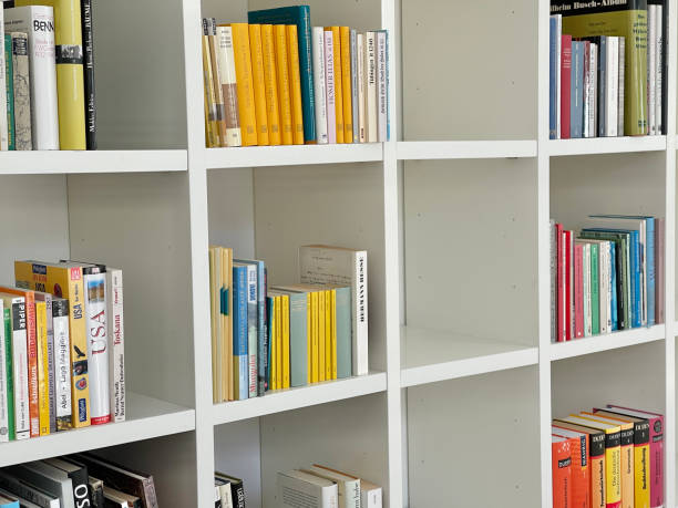 istock Filling the white bookshelf, close up 1303175954