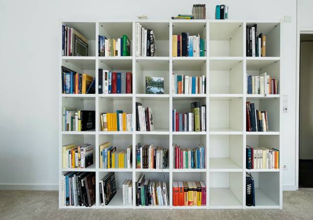 istock Filling the bookshelf, white wood 1303176024