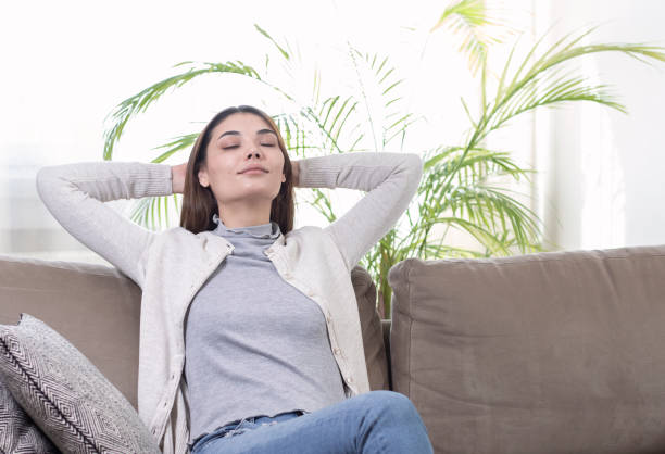 istock young woman relaxing on sofa 1303176363