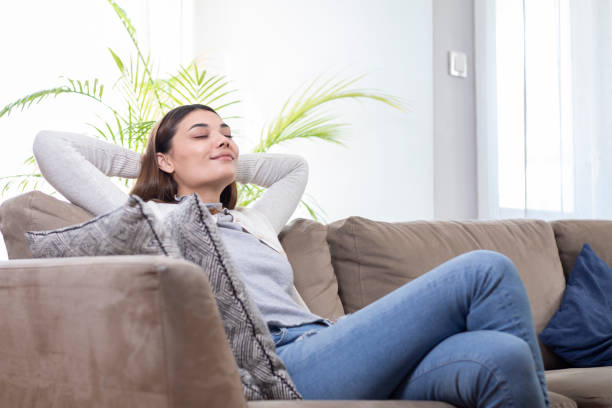 istock young woman relaxing on sofa 1303176364