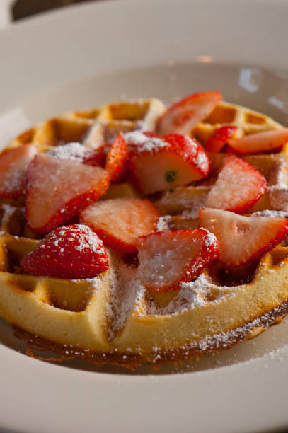 istock Waffles. Buttermilk waffles served with butter, maple syrup and crispy southern fried chicken. Classic American breakfast or brunch favorite. Waffles served with butter and maple syrup. 1303188864