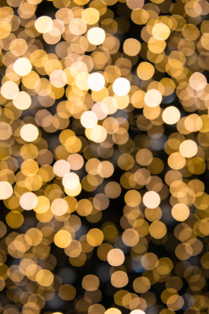 istock Dark background with golden bokeh circles of light 1303191861