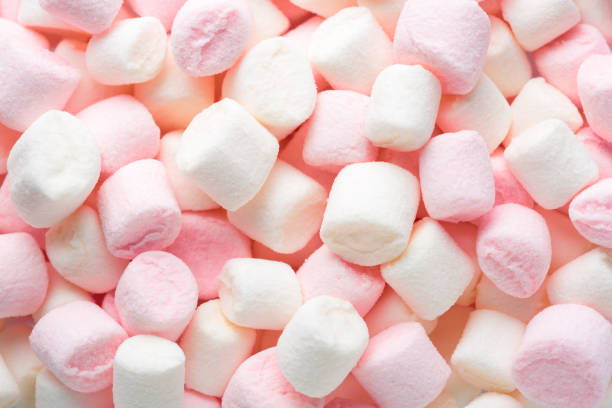 istock Mini marshmallows of white and light pink colors. Selective Focus. Top view. 1303192881