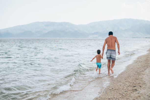 istock Father and son on the beach. 1303194331
