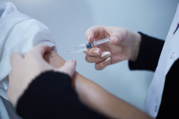 istock Young pharmacist makes corona vaccine 1303194404