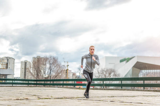 istock Young woman running outdoors. 1303197541