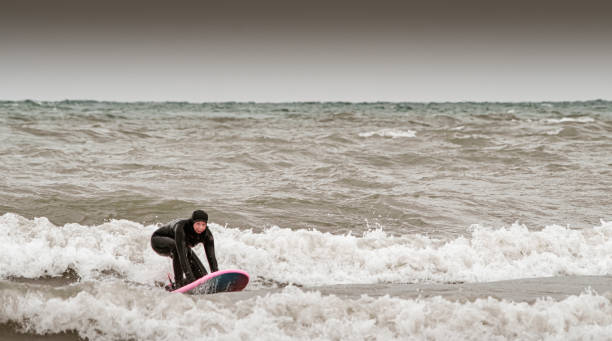 istock Young woman during winter surf 1303198674