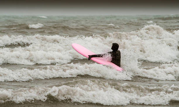 istock Young woman during winter surf 1303198765