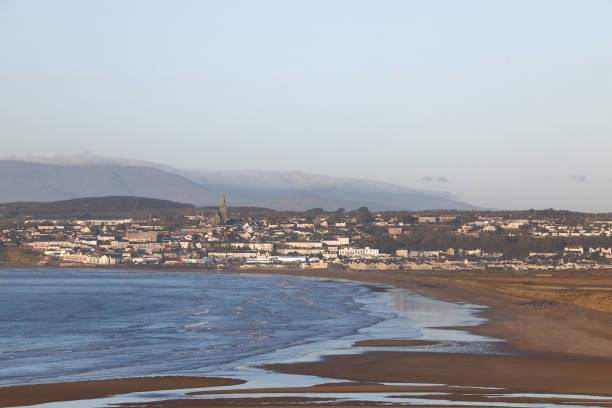 istock long beach with Irish town and cloudy mountains in the background. copy space. Tramore. Waterford. Ireland. 1303200822