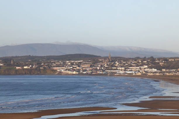 istock long beach with Irish town and cloudy mountains in the background. copy space. Tramore. Waterford. Ireland. 1303200840
