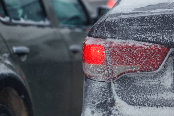 istock frosted car tail light with snow at winter evening, closeup with selective focus 1303203907