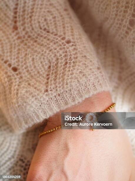 Gold Bracelet With Cultured Pearl And White Pullover On A Woman Stock Photo - Download Image Now