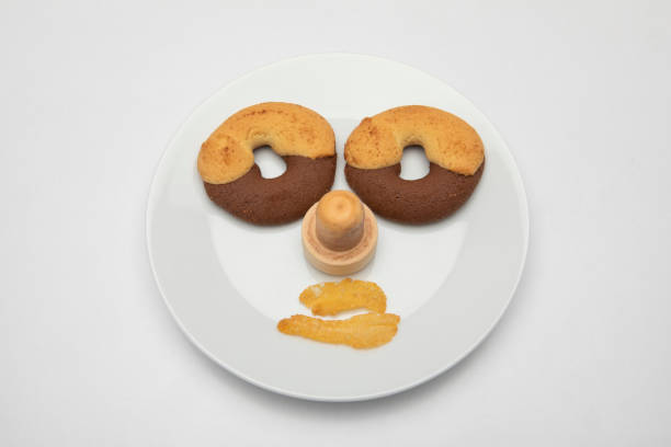 istock a face made of biscuits on a plate with cornflex mouth 1303204385