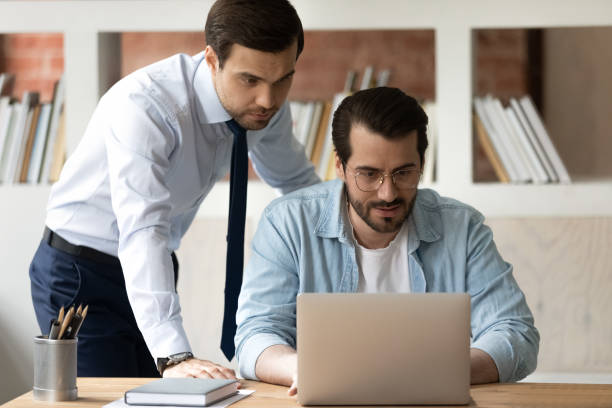 istock Male colleagues work together on laptop in office 1303206566