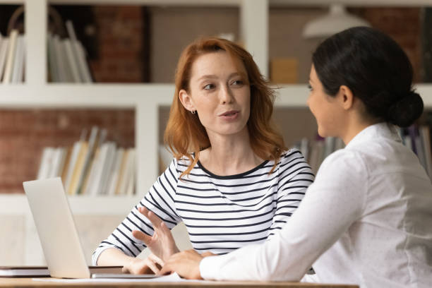 istock Multiracial female colleagues brainstorm ideas using laptop 1303206599