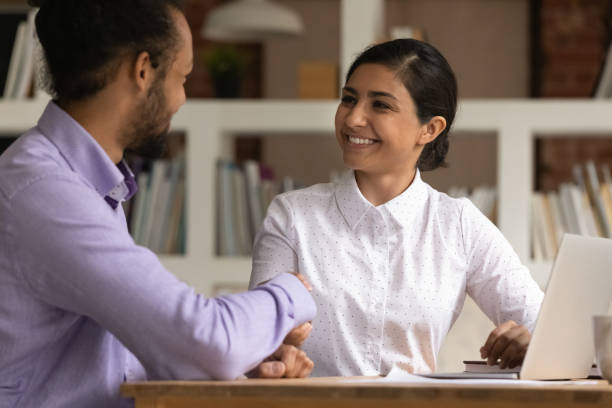 istock Smiling multiethnic businesspeople handshake getting acquainted at meeting 1303206601