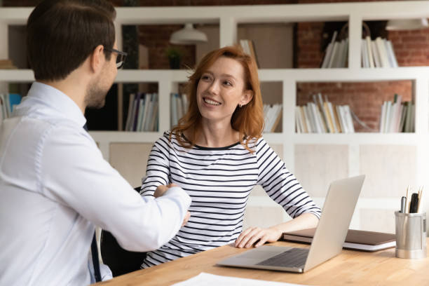 istock Smiling businesspeople shake hands making agreement at meeting 1303206612