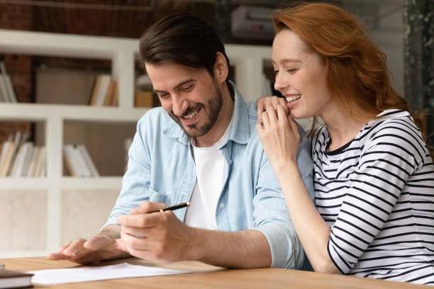 istock Excited couple clients sign document closing deal 1303206614