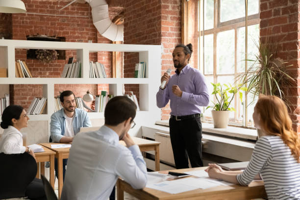 istock African American male leader talk in microphone in office 1303206628