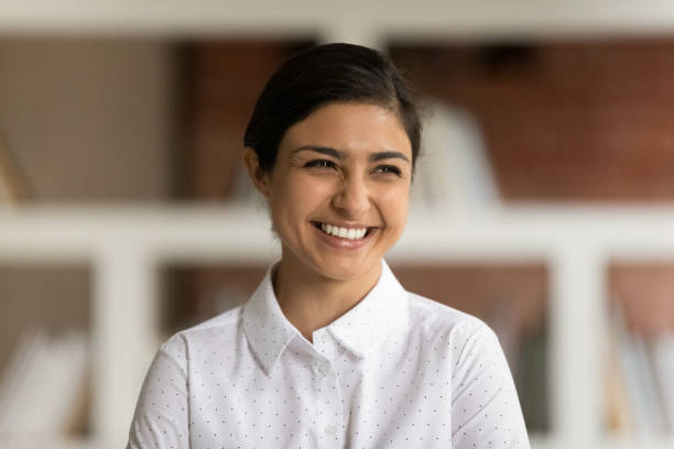 istock Smiling Indian woman look in distance visualizing 1303206647