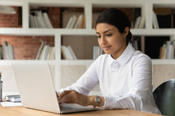 istock Young Indian female employee work on laptop 1303206651