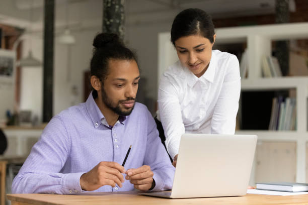 istock Multiethnic colleagues work together on laptop in office 1303206666