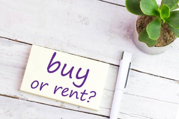 istock buy or rent? text on a sticker on wooden table 1303206710