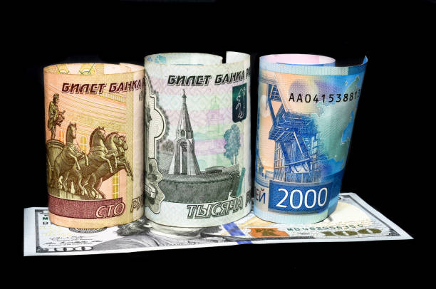 istock Russian rubles and American dollar bills. Russian ruble is going down or growing up. 1303206976