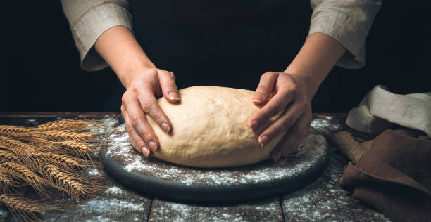 istock The cook holds the dough with his hands on a dark background 1303209074