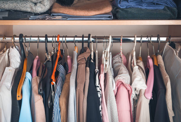 Things on hangers and on a shelf in the closet Things on hangers and on a shelf in the closet. Side view, horizontal. colorful check shirts on sale at a clothing store stock pictures, royalty-free photos & images