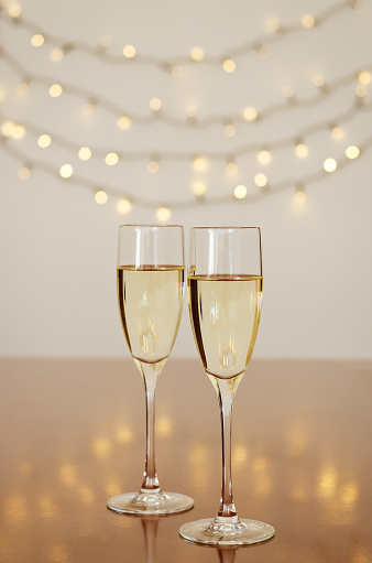 Two glasses of champagne or wine with bokeh background close up. Top view. New Year. Christmas time. Greeting card. Holiday and party concept.