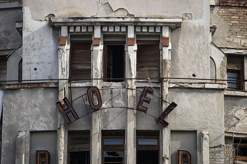 Bucharest, Romania - February 10, 2021: The ruined building of the abandoned Dunarea Hotel, owned by Real Sol, real estate company that wants to turn it into a block of flats, in Bucharest.