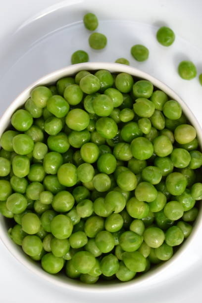 istock Fresh green peas are on a plate 1303212716