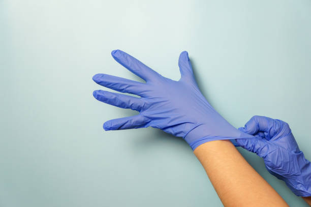 istock Woman puts her hands in gloves 1303213601