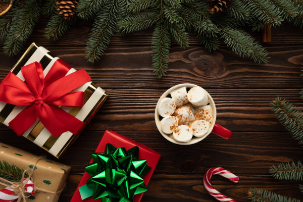 istock There is a cup of hot chocolate with marshmallows on a table decorated with Christmas decor 1303213638