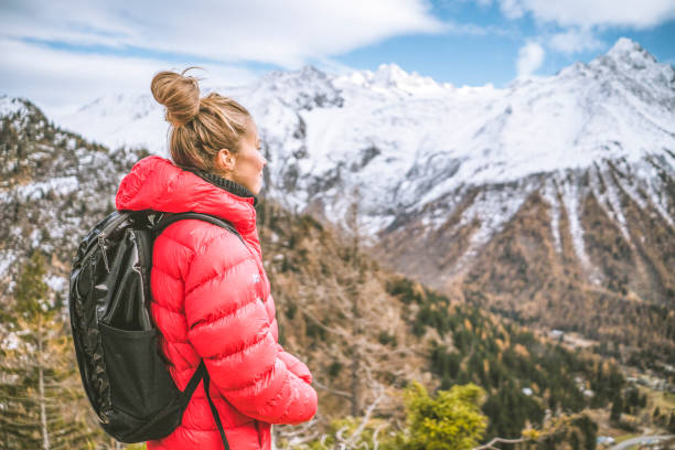 istock Hiker pauses on sunny mountain ridge 1303215818