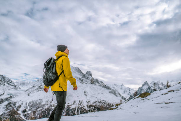 istock Hiker walks along a snowy mountain ridge 1303215911