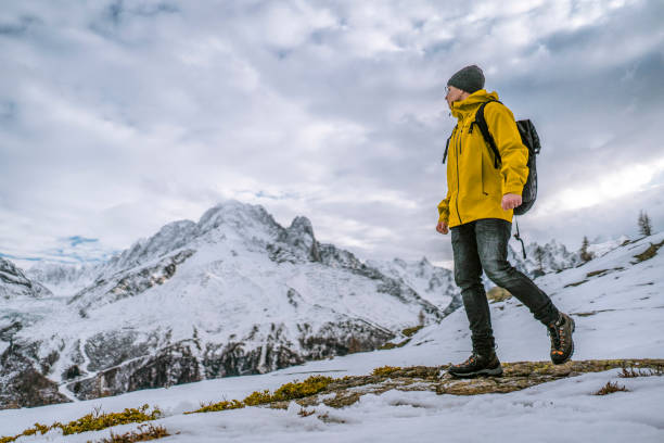 istock Hiker walks along a snowy mountain ridge 1303215991