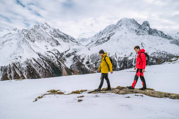 istock Hikers explore snowy ridge in mountains 1303216058