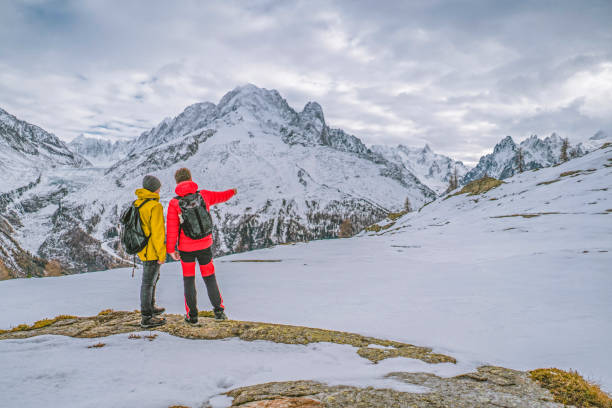 istock Hikers look off to distant snowcapped mountains 1303216118