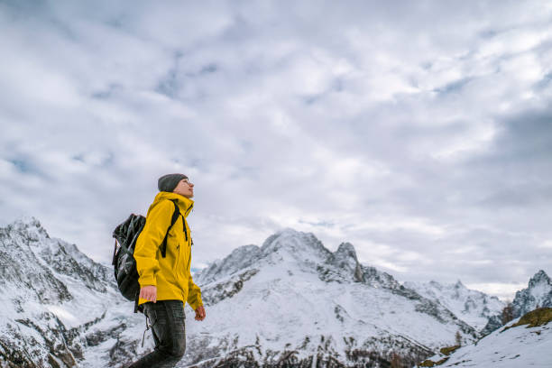 istock Hiker walks along a snowy mountain ridge 1303216201