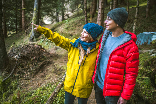 istock Young couple pause on forest trail and look out 1303217977