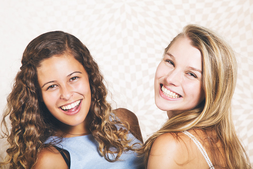 Woman in her early 20s with her best friend, a beautiful blonde a couple of years younger.