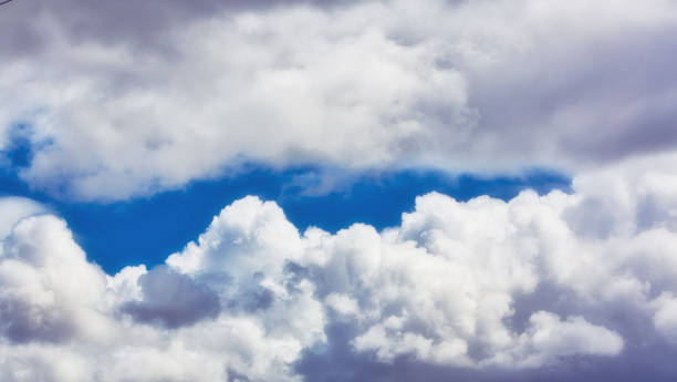 istock Puffy cumulus cloud with a sliver of blue sky 1303219665