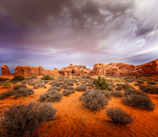 istock Dramatic clouds over the window section in the Arches National Park, Utah 1303222612