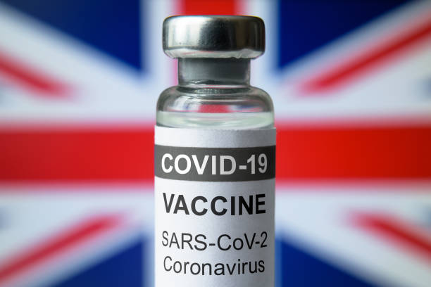 istock COVID-19 vaccine on UK flag background 1303223582