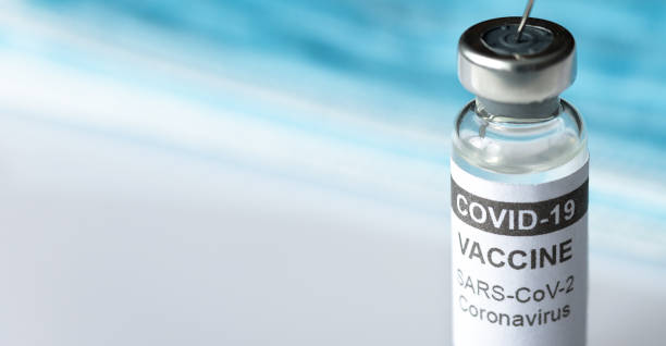 istock Panoramic view of COVID-19 vaccine bottle and copy space for text, coronavirus banner 1303223614