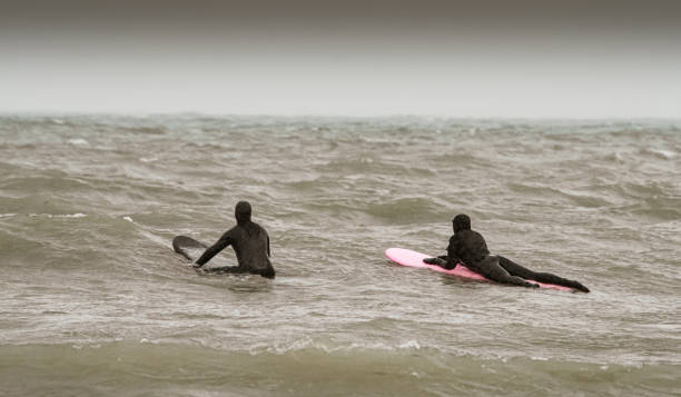 istock Young couple on the waves ready to surf 1303223901