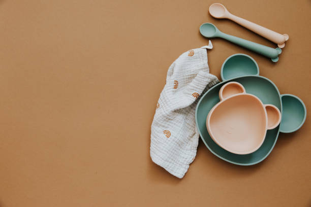 istock Flat lay composition with baby food accessory, plastic fruits, on light background. First baby food concept 1303224811