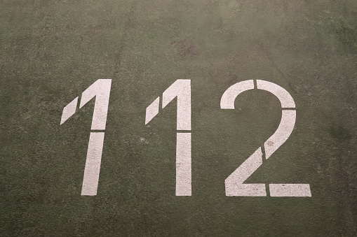Numbers painted on concrete and asphalt textured surfaces